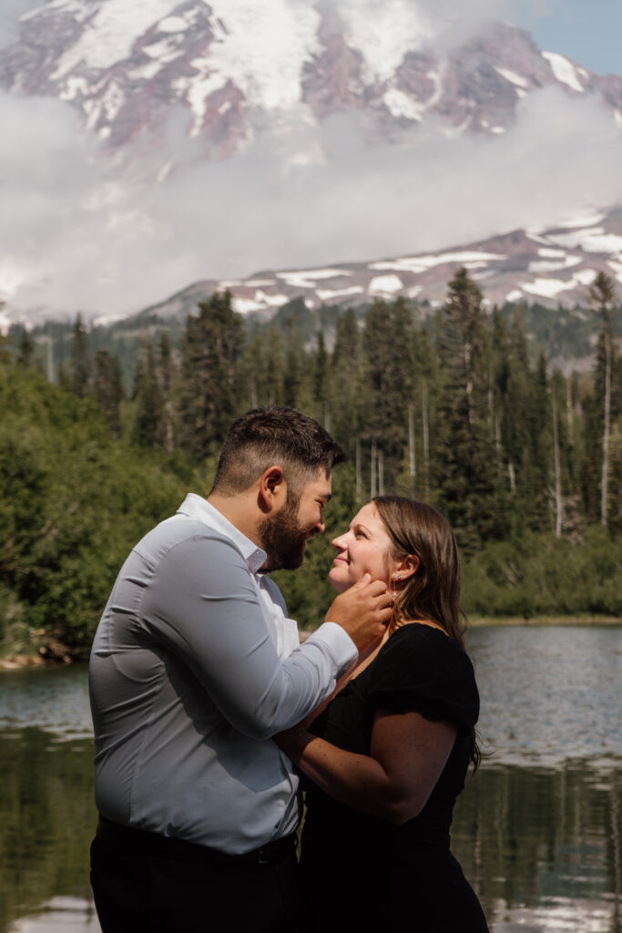 Couple looking into eachother's eyes with Mount Rainier in the background at bench lake.