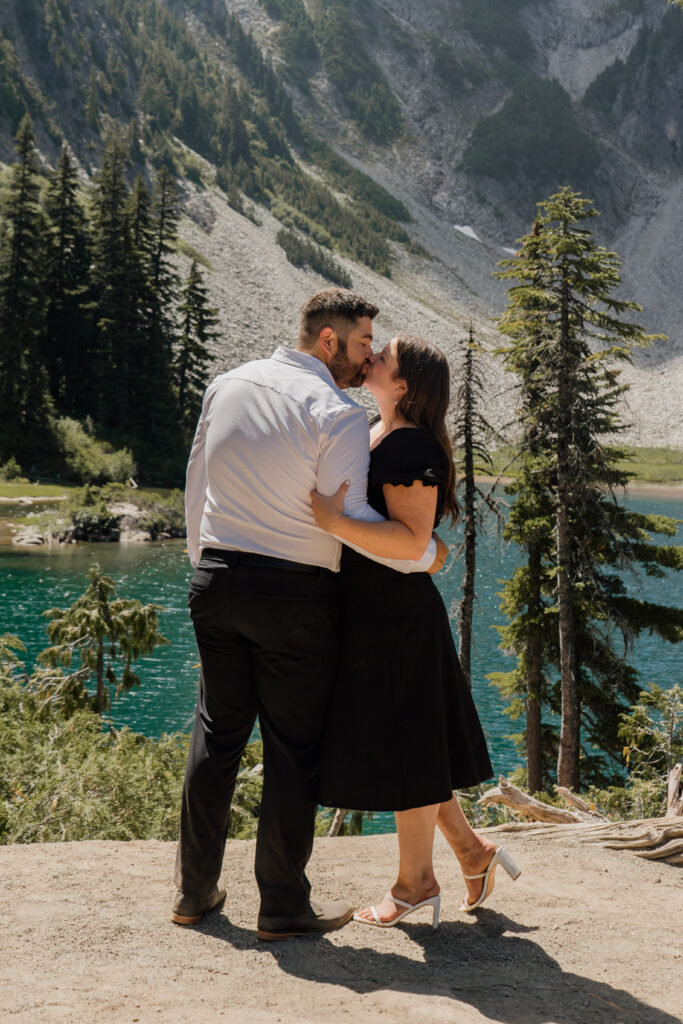 Couple kissing in front Snow lake.