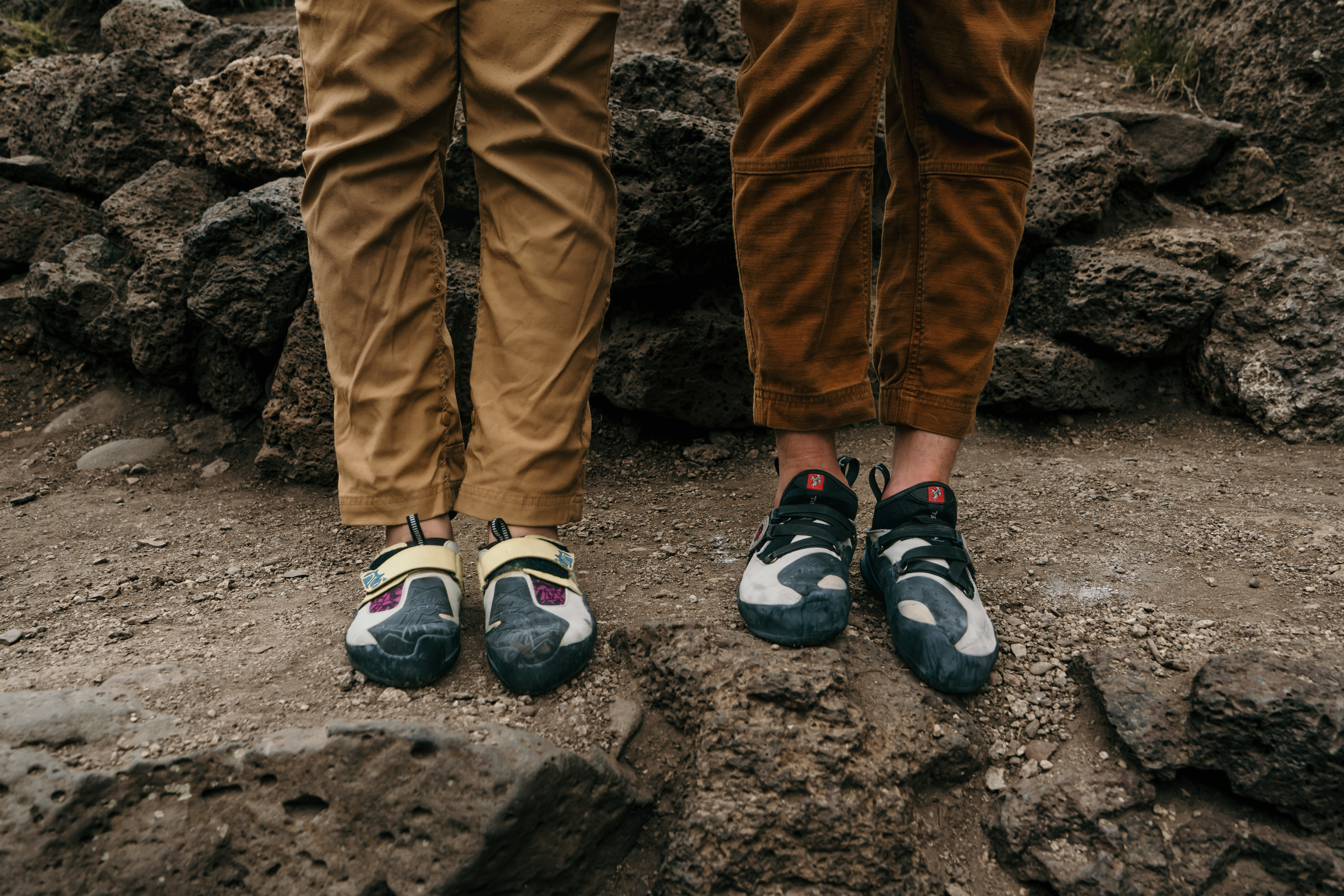 Knees down photo of a couple wearing outdoor rock climbing shoes during an adventure photo session at Smith Rock State Park.