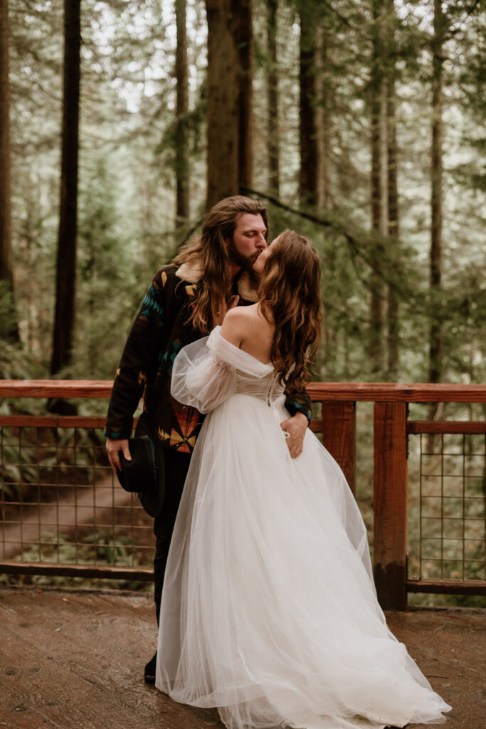 Bride and Groom kissing on the Redwood Deck in Portland, Oregon.