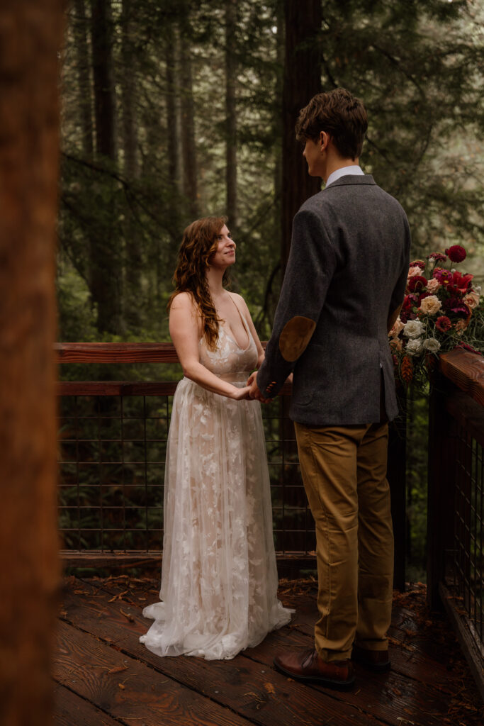 Couple in wedding attire exchanging vows on the Redwood Deck at Hoyt Arboretum.