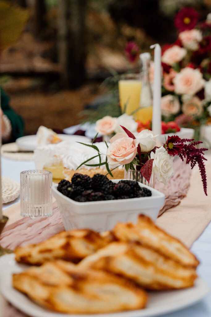 Tablescape photo with pastries, berries, and florals during a couples brunch at their Trillium Lake Elopement.