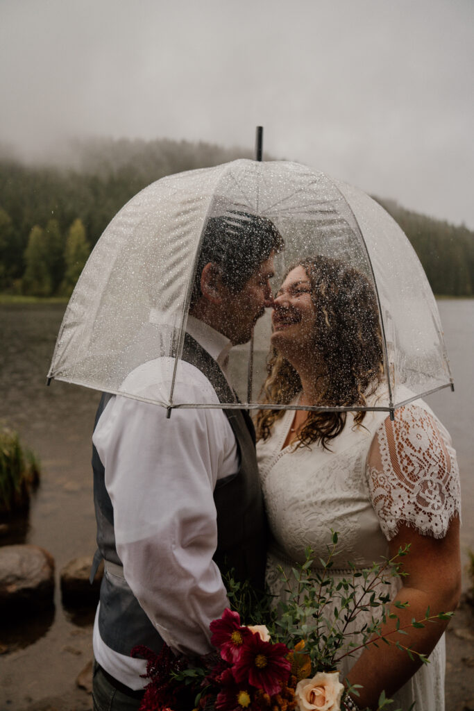 Bride and Groom during their first dance in the rain during their Canoe Elopement at Trillium Lake.