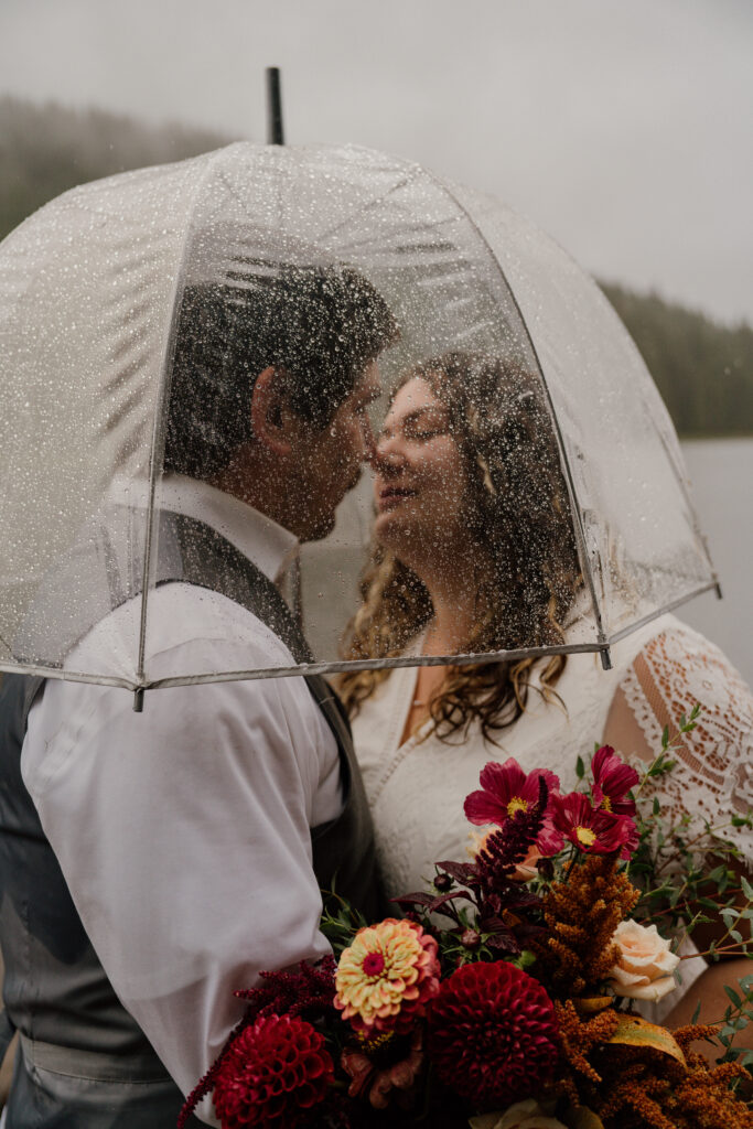 Elopement couple during their first dance in the rain during their Canoe Elopement at Trillium Lake in Oregon.