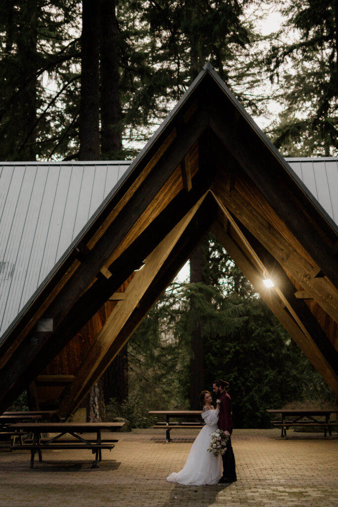 Couple hugging in wedding attire during their Hoyt Arboretum Elopement.