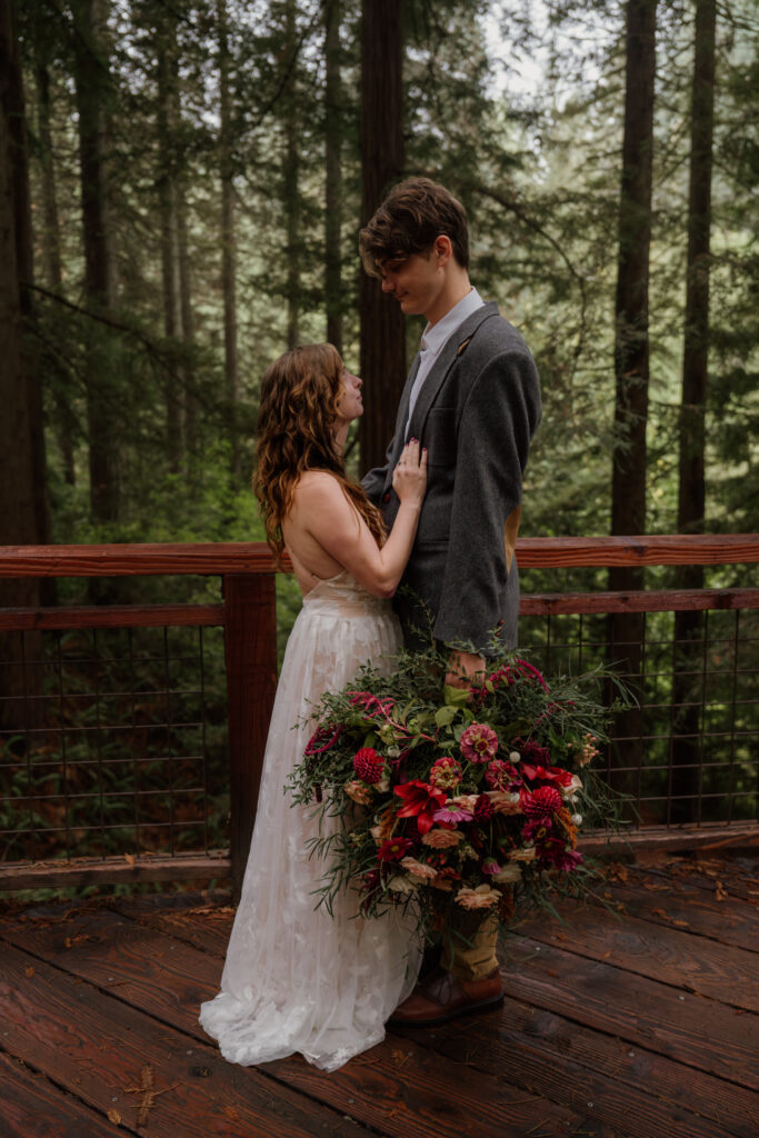 Couple looking into eachothers eyes on the Redwood Deck at Hoyt Arboretum.