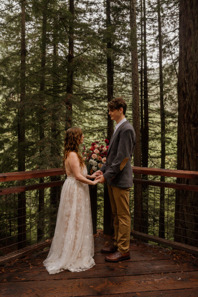 Couple exchanging vows at their Hoyt Arboretum Elopement.