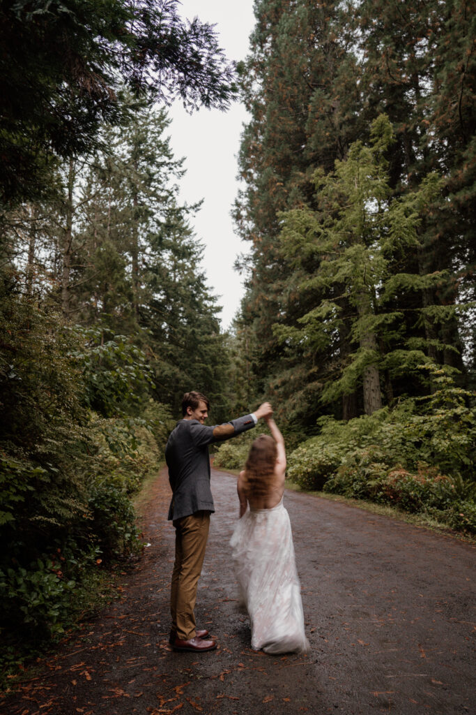 Bride spinning during a dancing photo at Hoyt Arboretum after their intimate elopement.