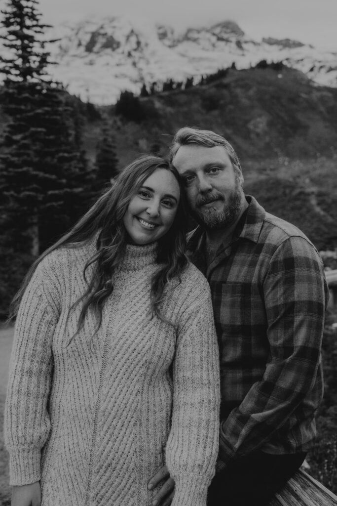 B+W photo of couple with Mount Rainier in the background.