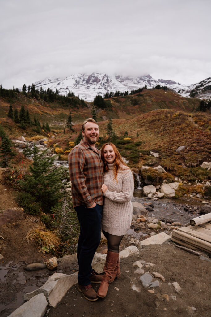 Couple hiking during their Mount Rainier adventure engagement session.