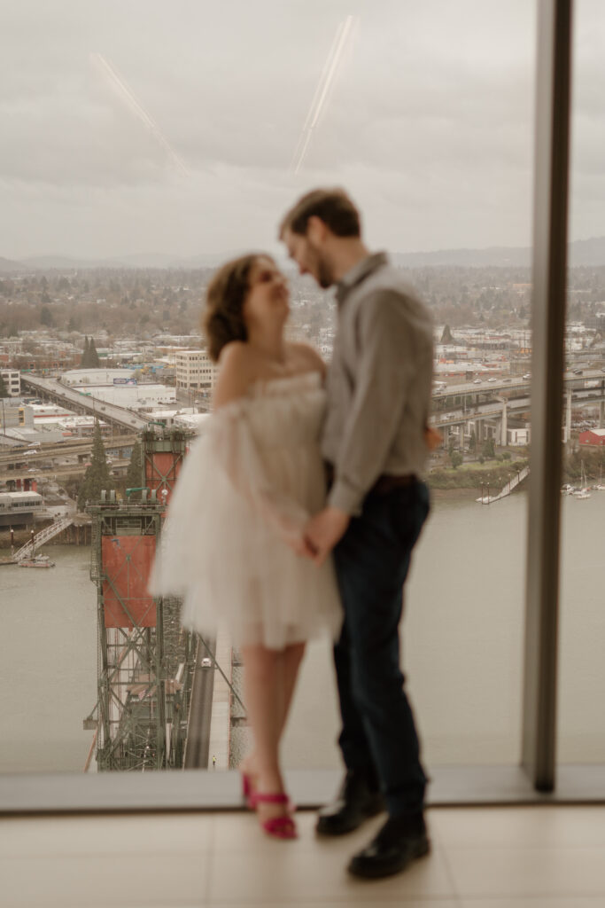 Couple looking at eachother in wedding attire during their courthouse elopement in Portland, Oregon.