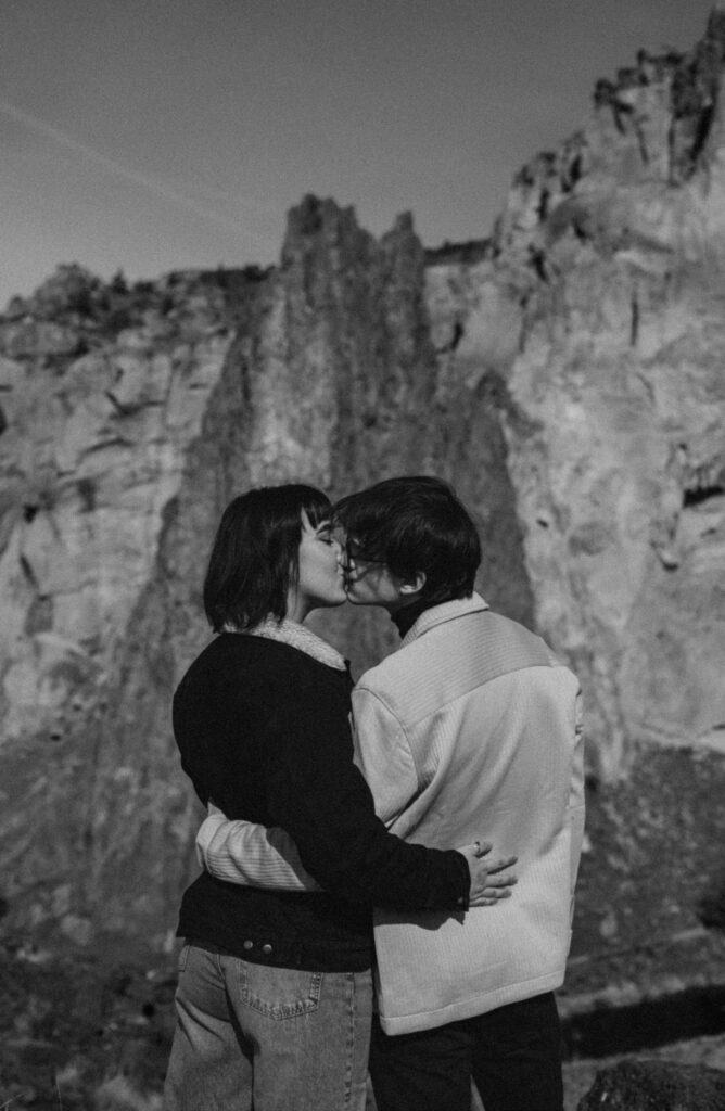 Couple kissing during their adventure session at smith rock state park.