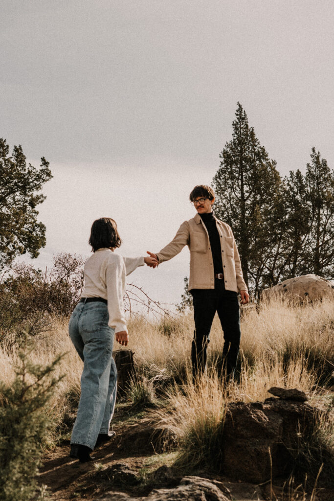 Couple with film aesthetic editing holding hands during their adventure session photo shoot at smith rock state park.