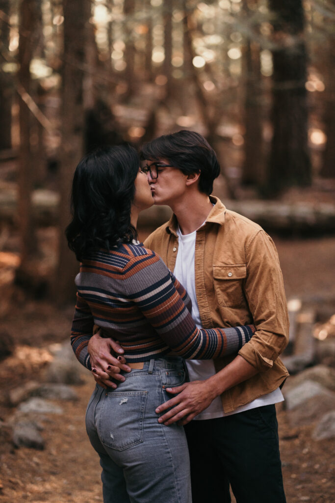 Couple kissing at Trillium Lake for their engagement photos.