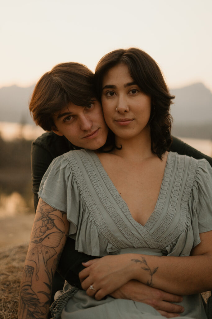 Couple hugging while at Government Cove during their engagement photos.