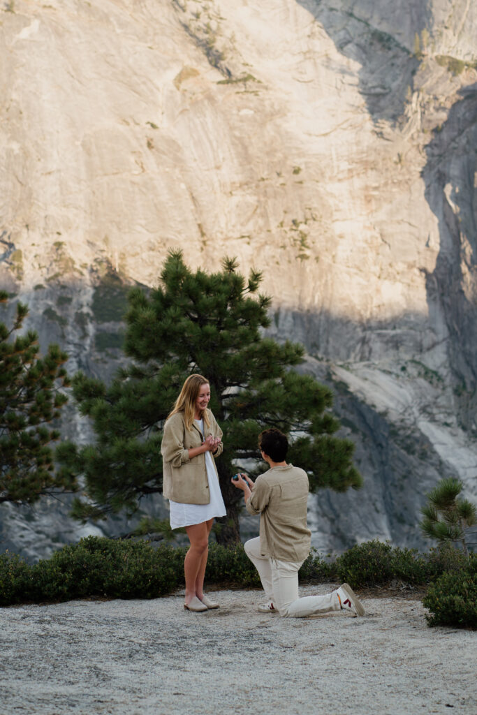 Man on one knee and proposing in Yosemite National Park.