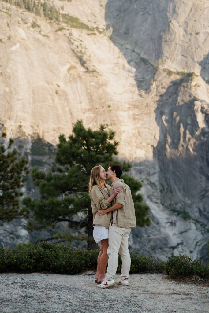 Couple kissing after getting engaged in Yosemite National Park.