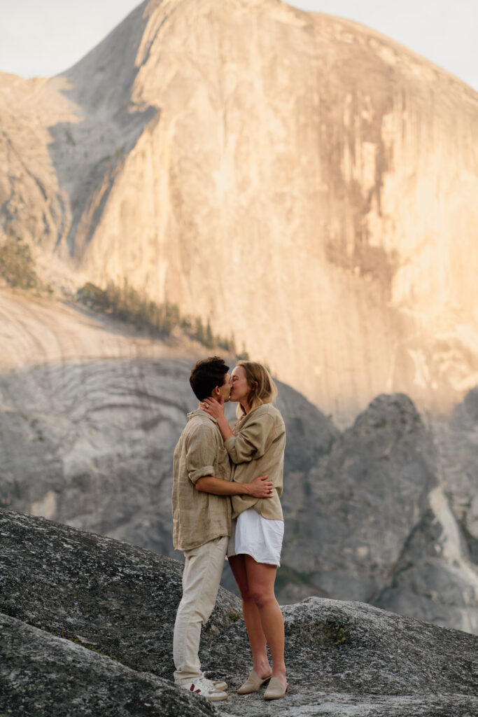 Couple kissing with the Iconic Yosemite Half dome in the background.