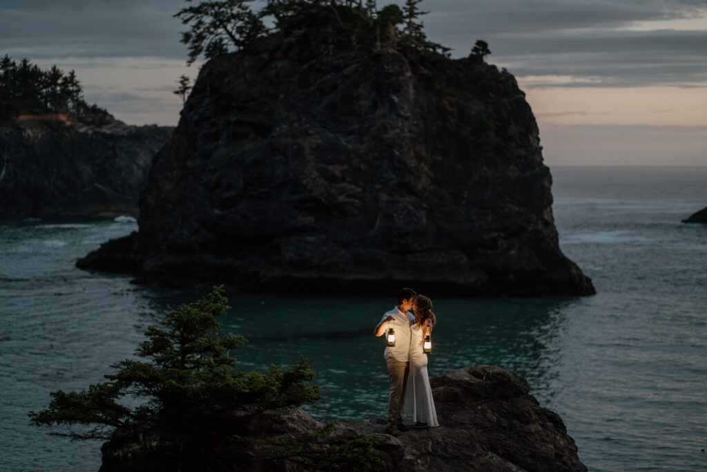 Couple holding lanterns as it begins to get dark on their Samuel H Boardman Adventure Elopement.