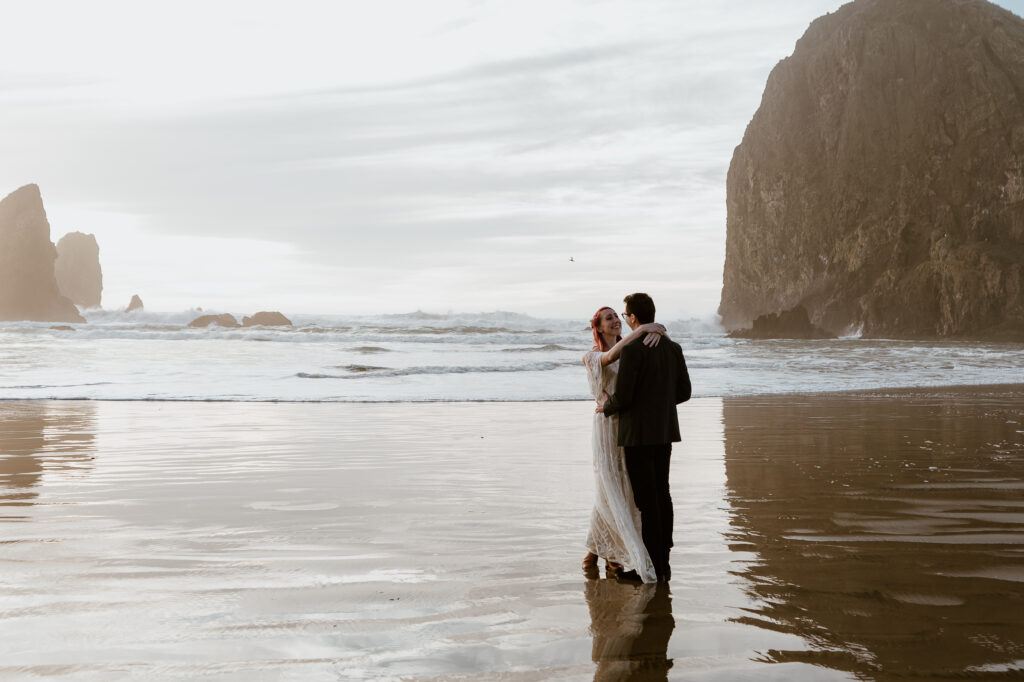 Bride and groom dancing on Cannon Beach during their Cannon Beach and Ecola State Park Elopement on the Oregon Coast.