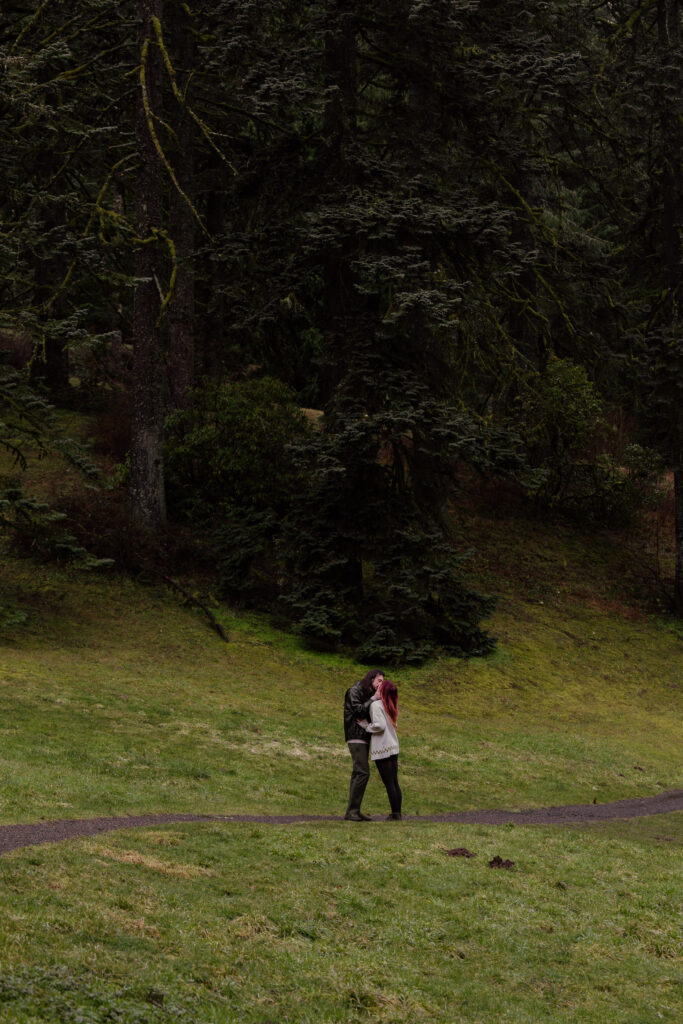 Couple kissing on the Redwood Trail at Hoyt Arboretum.