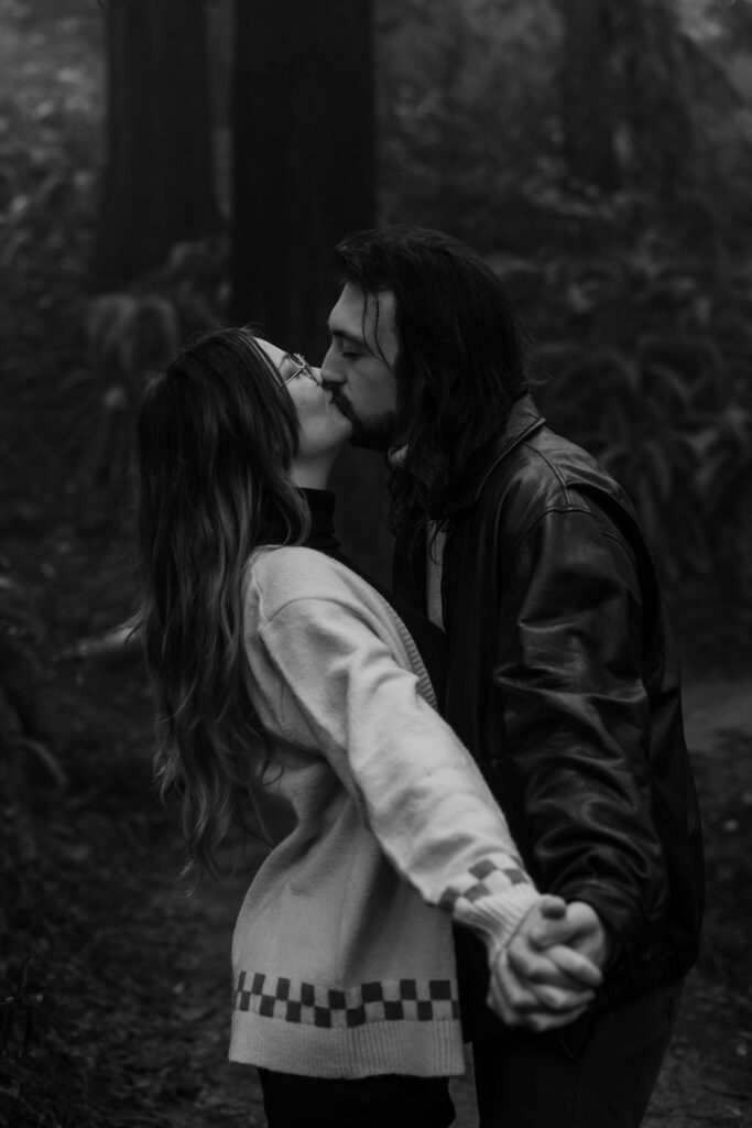 B+W photo of couple kissing during their engagement session in Oregon.