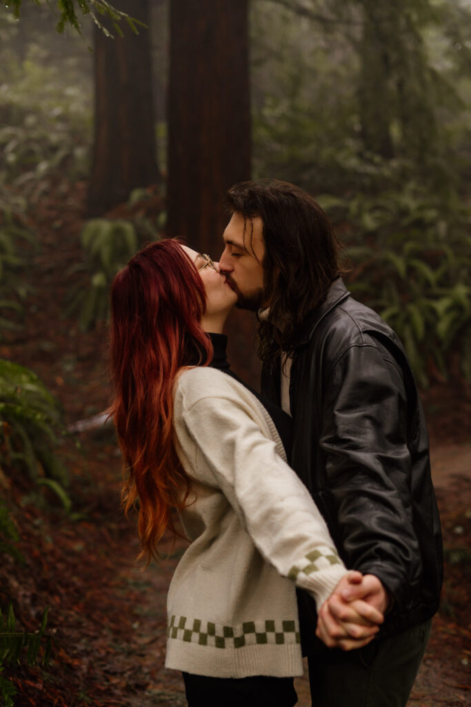 Couple kissing during their engagement photos at Hoyt Arboretum.