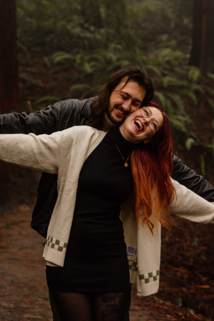 Couple laughing and hugging during their Hoyt Arboretum Engagement Session.