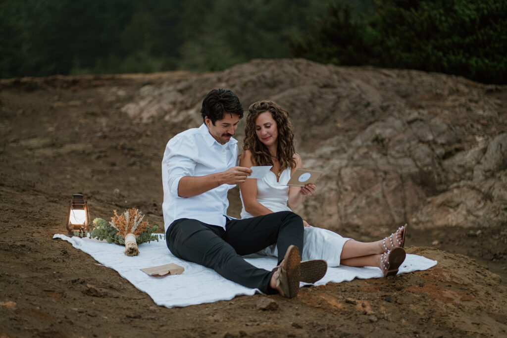 Couple reading a letter during their Oregon Coast Adventure Elopement in the Samuel H Boardman Scenic Corridor.