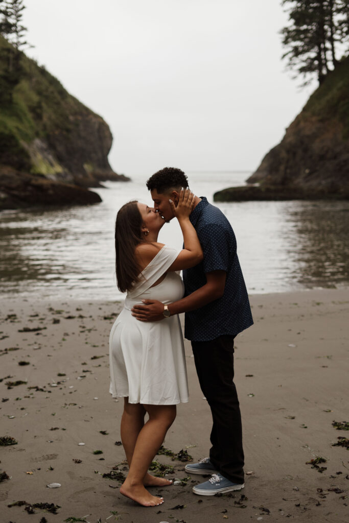 Couple standing and kissing during their Washington Coast Engagement Session.