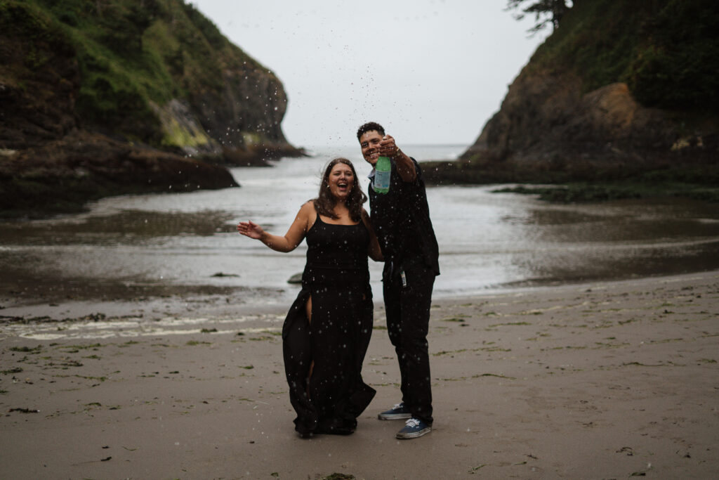 Couple popping champagne (sparkling water) on the Washington Coast.