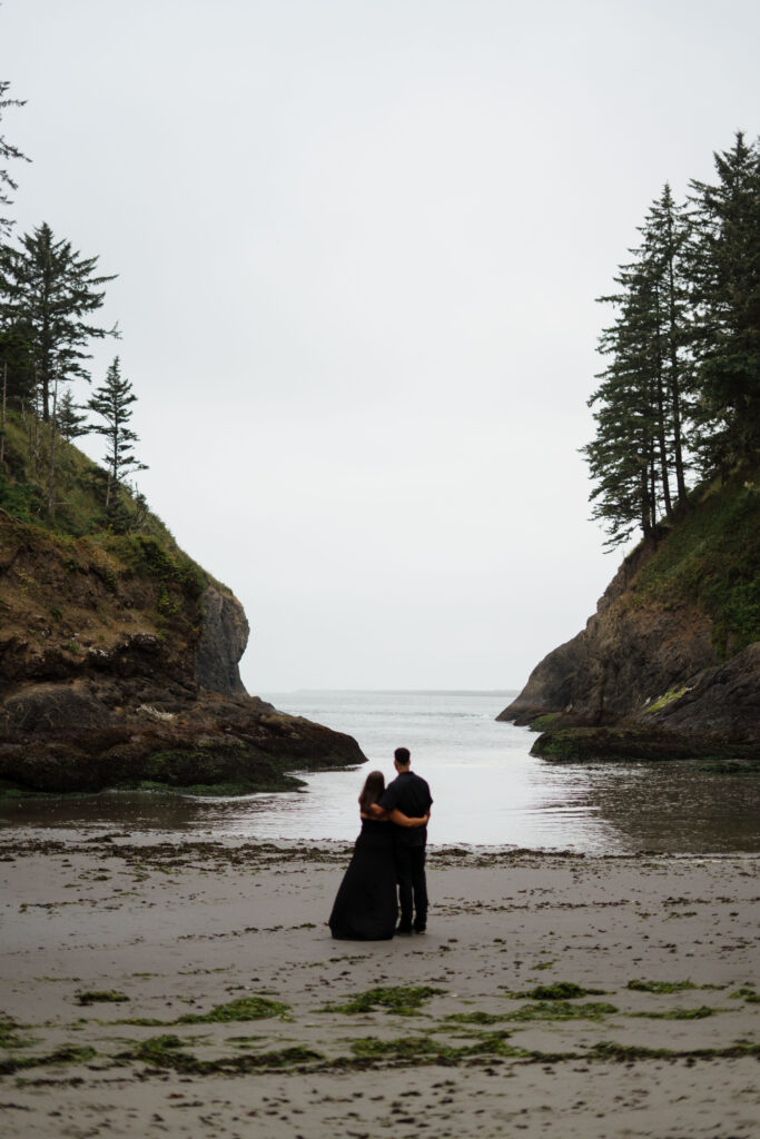 Couple hugging and looking out at the Washington Coastline. 