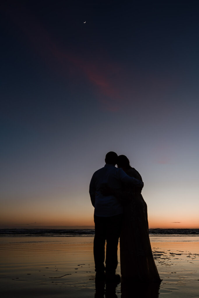 Couple looking up at the moon during their Oregon Coast Elopement.