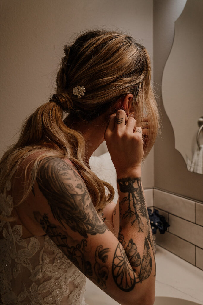 Bride putting in her earrings