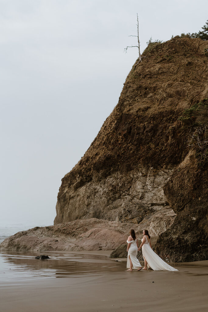 Couple walks towards the ocean on Arcadia Beach