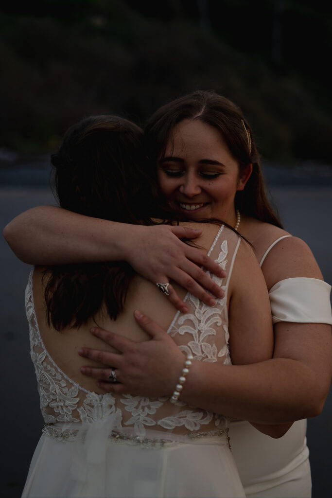 Two women hugging intimately after their beach ceremony on the Oregon Coast