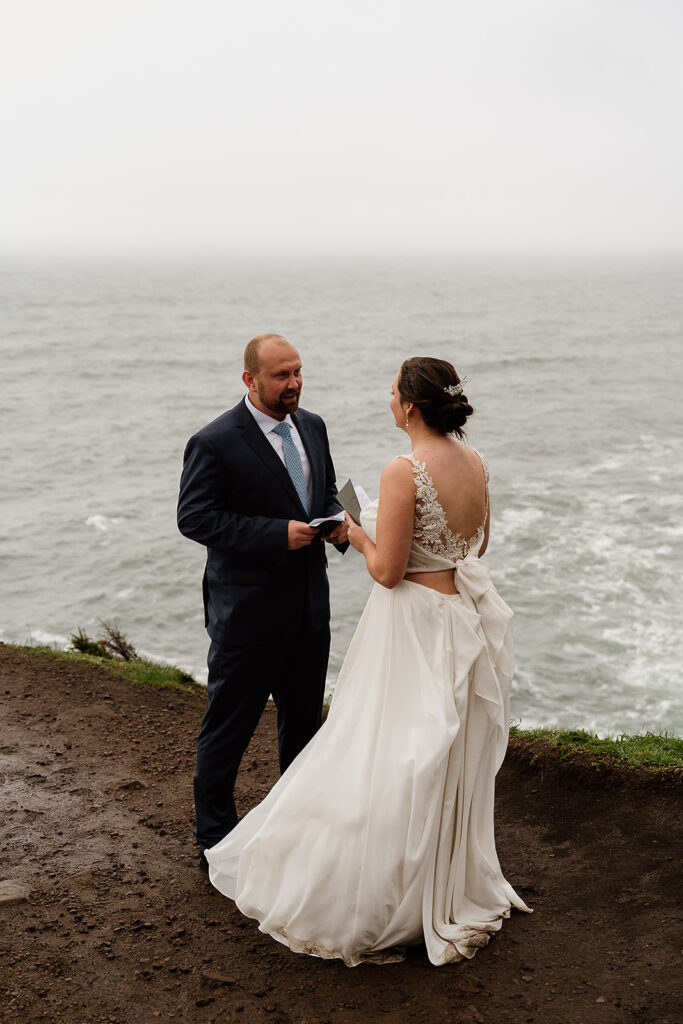 Couple reading their private vows cliffside