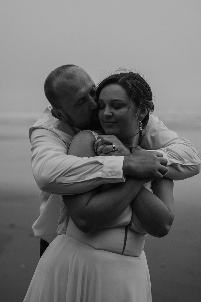 Couple hugging closely on the beach