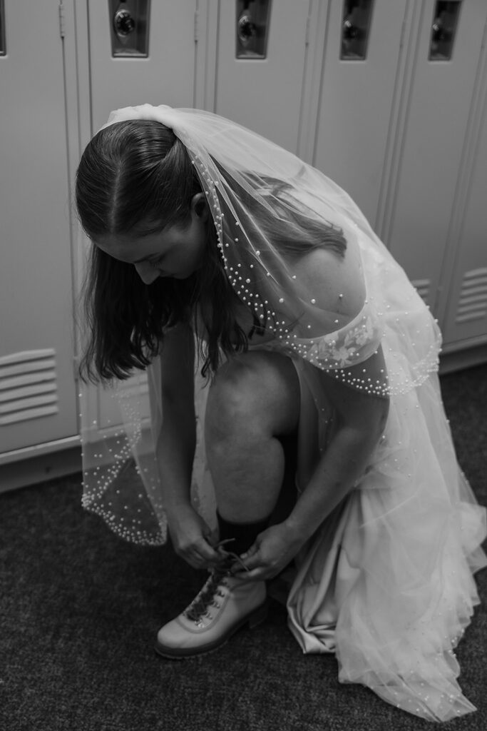 Bride tying up her hiking boots for an Oregon adventure elopement at Hoodoo Ski Area