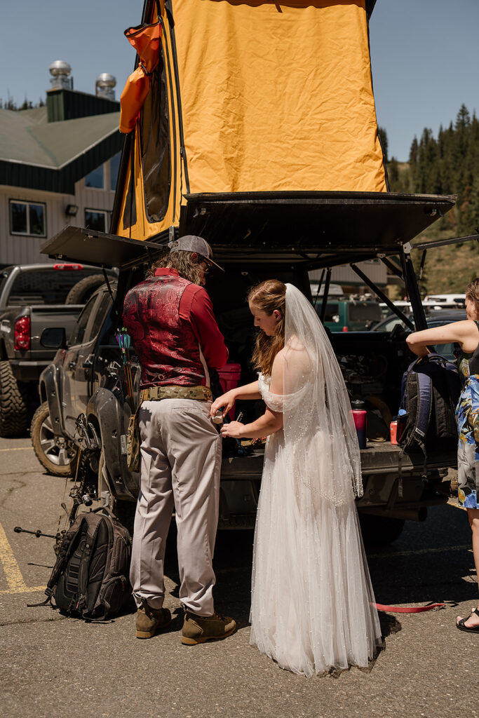 Bride and groom get their archery gear ready for their Oregon adventure elopement at Hoodoo Ski Area