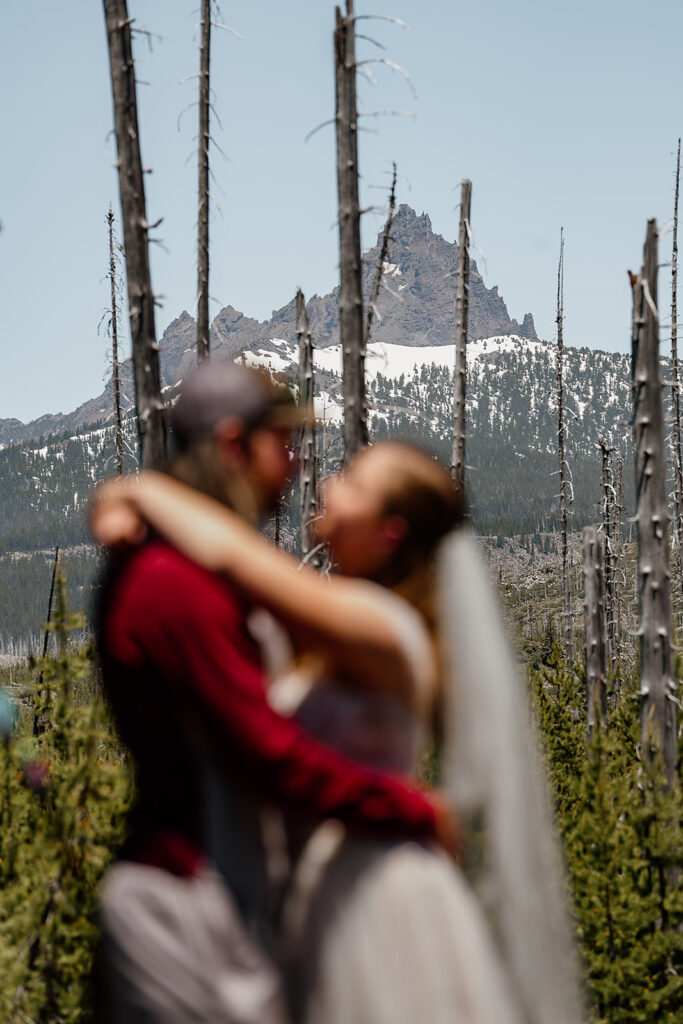 Blurry bride and groom with a mountain in the backdrop