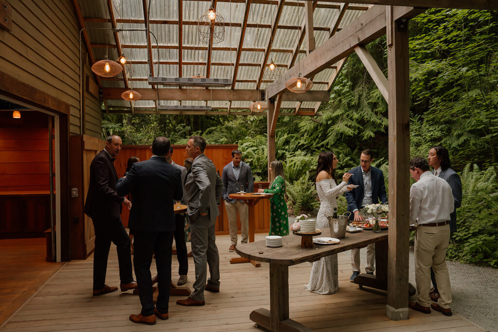 Guest's gather around at an intimate Treehouse Point wedding reception