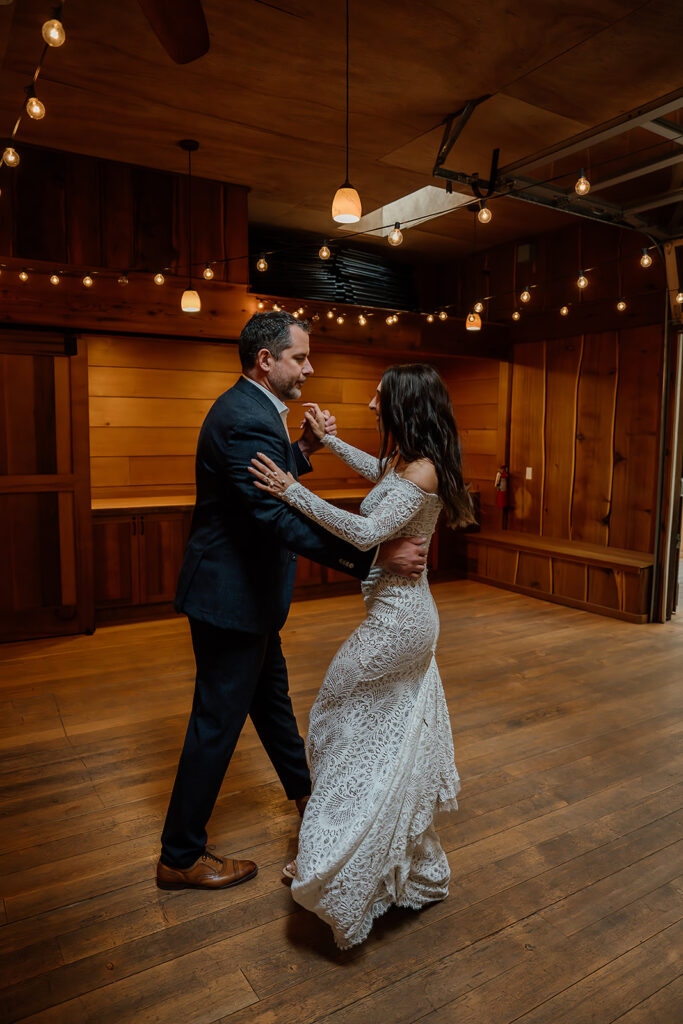 Bride and grooms fun first dance in the Treehouse Point reception area