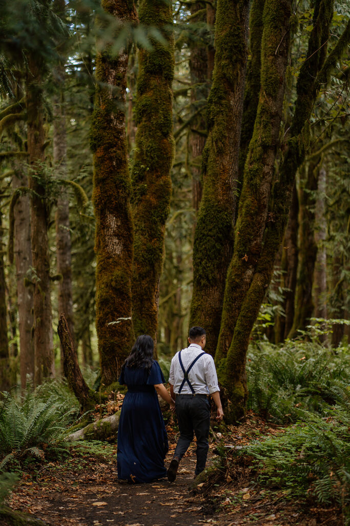 Couple walks through the forest at Wildwood Recreation Site for their outdoor photoshoot