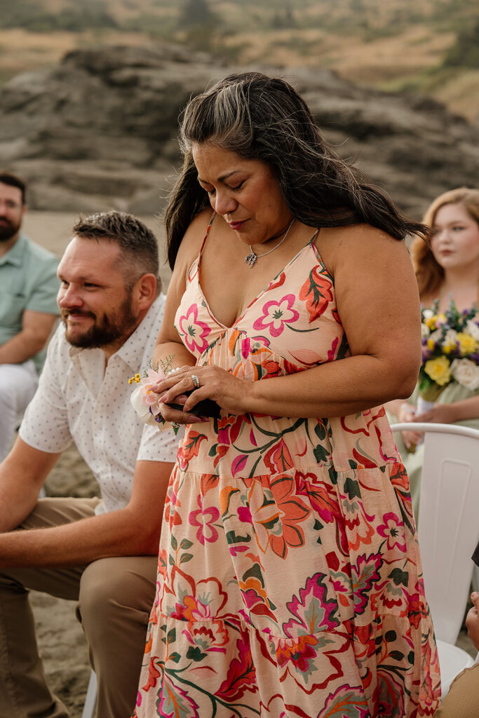 Wedding guests pray over the bride and grooms rings during their Oregon micro wedding ceremony