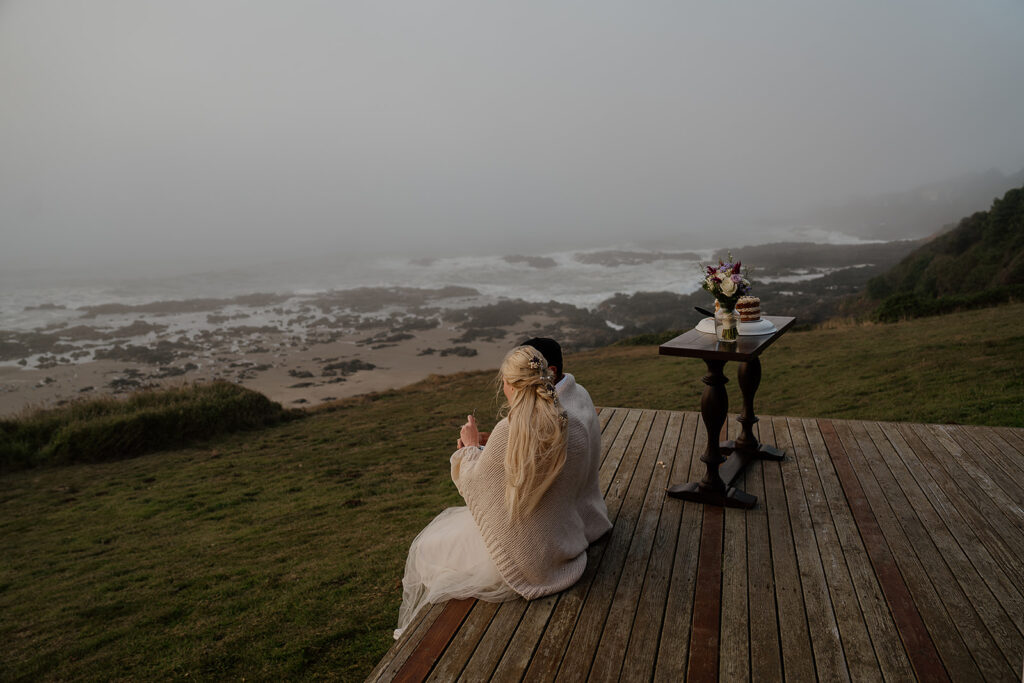 Bride and groom eat their elopement cake on the porch of their Oregon Airbnb