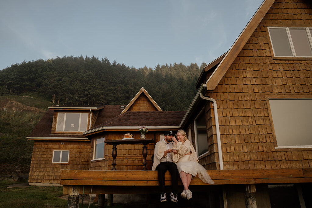 Bride and groom eat their elopement cake on the porch of their Oregon Airbnb