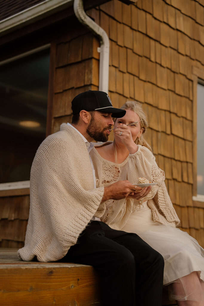 Bride and groom eat their elopement cake on the porch of their Oregon Airbnb