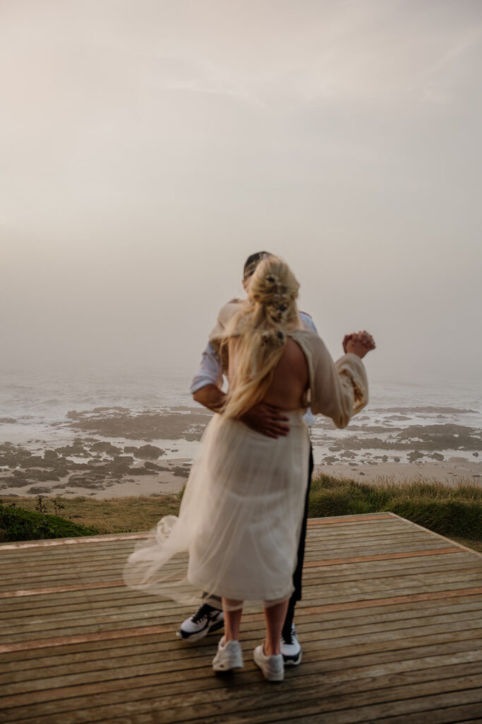 Bride and groom dance on the porch of their Oregon Coast Airbnb