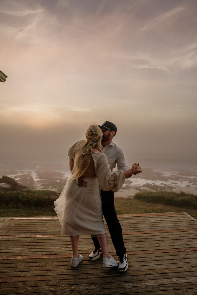 Bride and groom dance on the porch of their Oregon Coast Airbnb